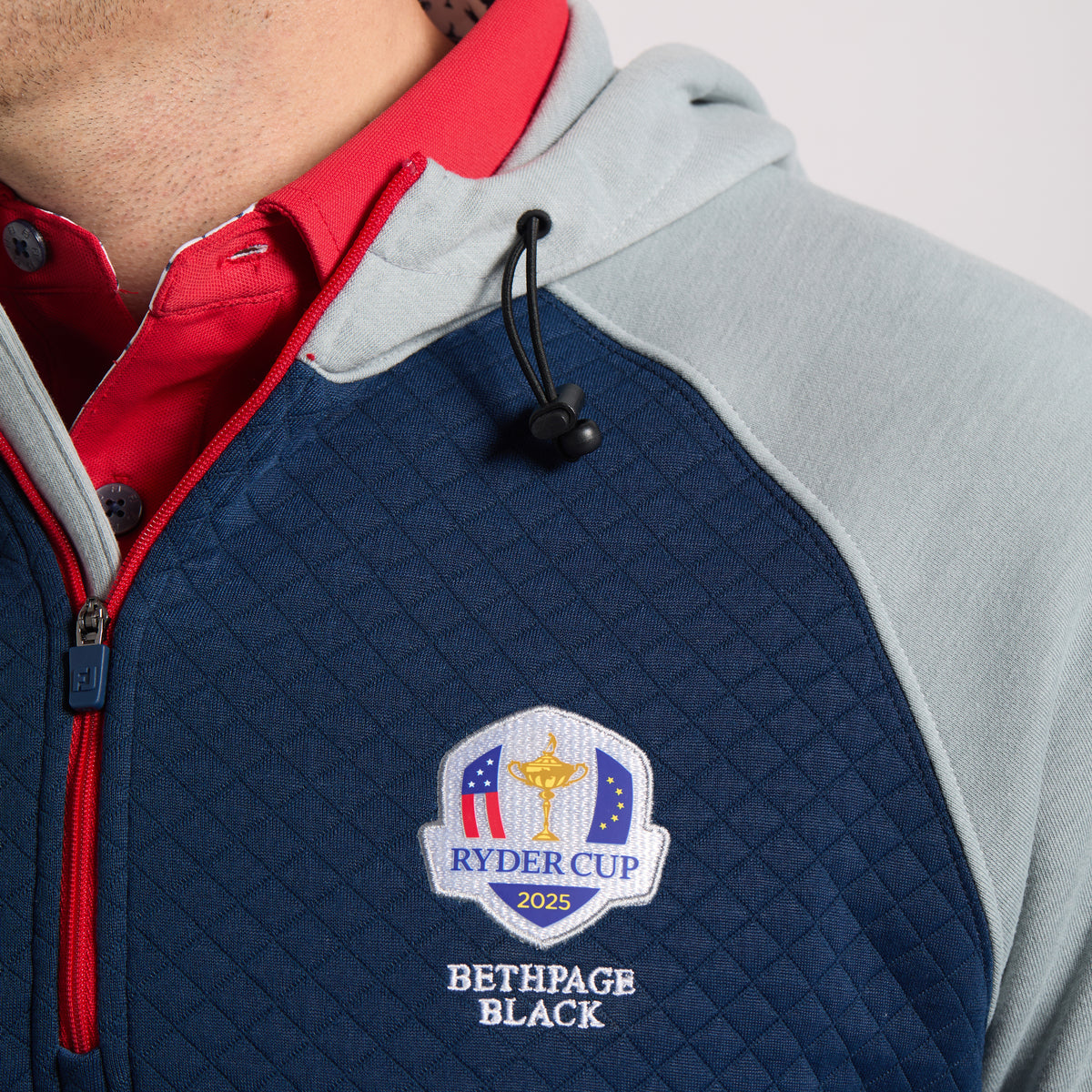 FootJoy 2025 Ryder Cup Hybrid Quarter Zip Hoodie in Navy and Grey - Logo Close Up